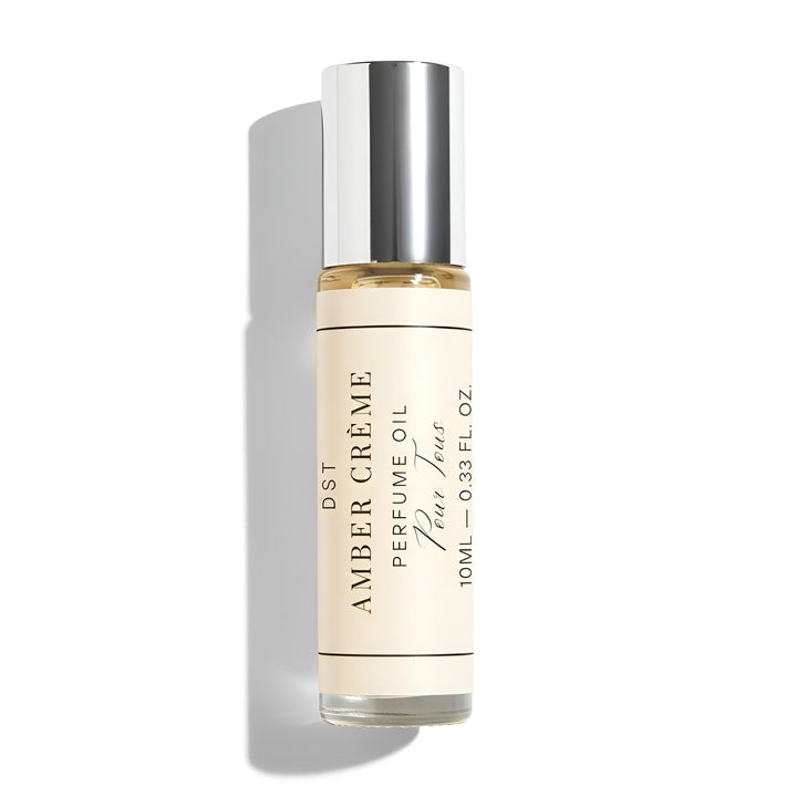 Perfume oil bottle labeled 'Amber Creme' on a white background