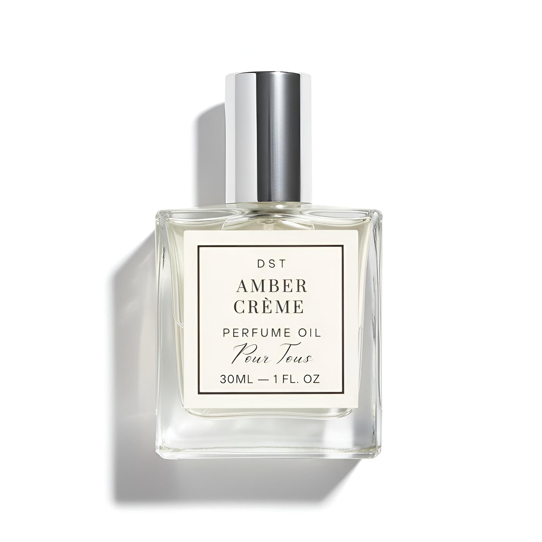 Perfume oil bottle labeled 'Amber Cèreme' on a white background