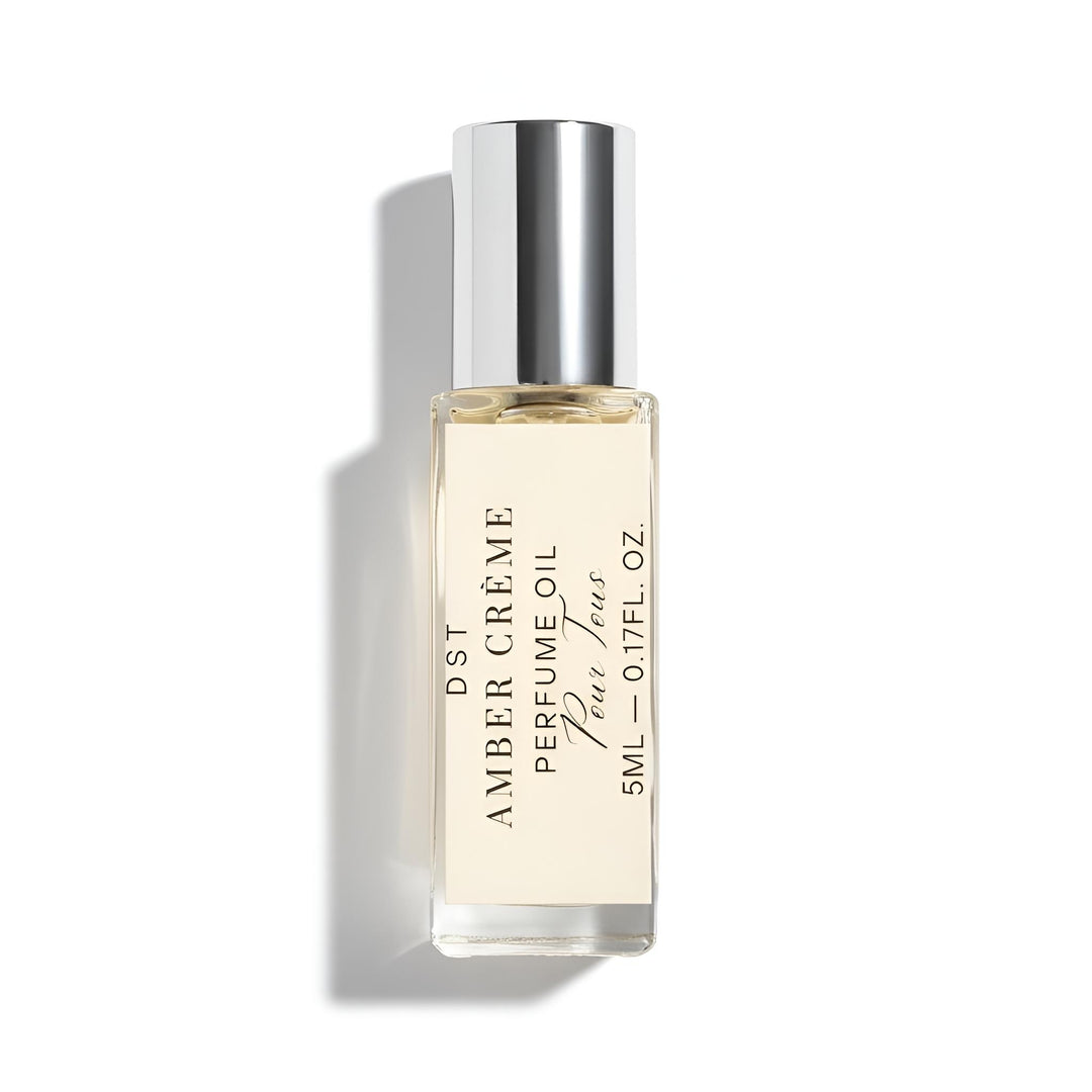 Perfume oil bottle labeled 'Amber Creme' on a white background