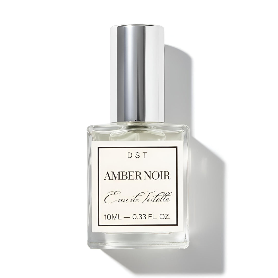 Perfume bottle labeled 'Amber Noir' by DST on a white background