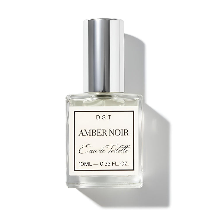 Perfume bottle labeled 'Amber Noir' by DST on a white background
