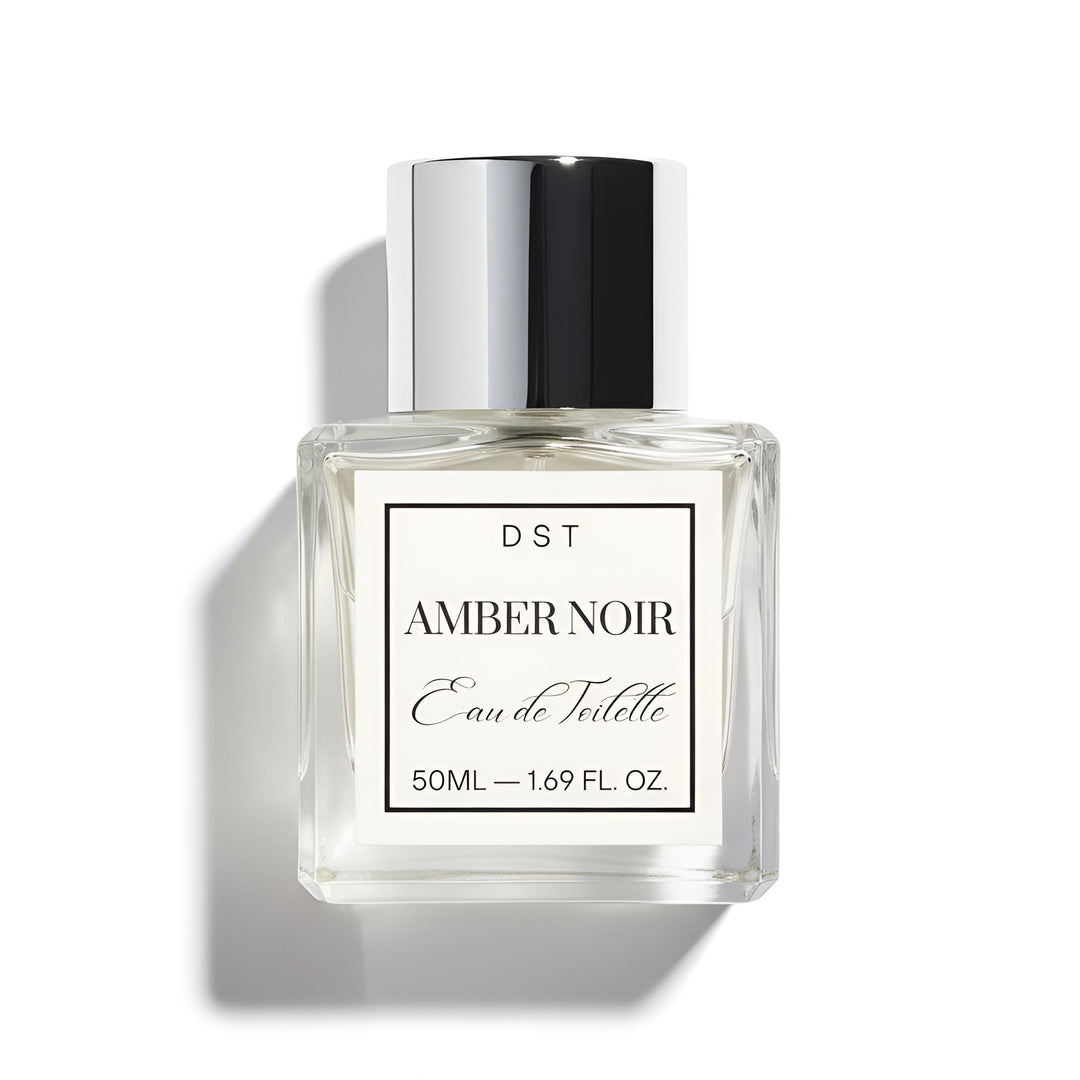 Perfume bottle labeled 'Amber Noir' by DST on a white background