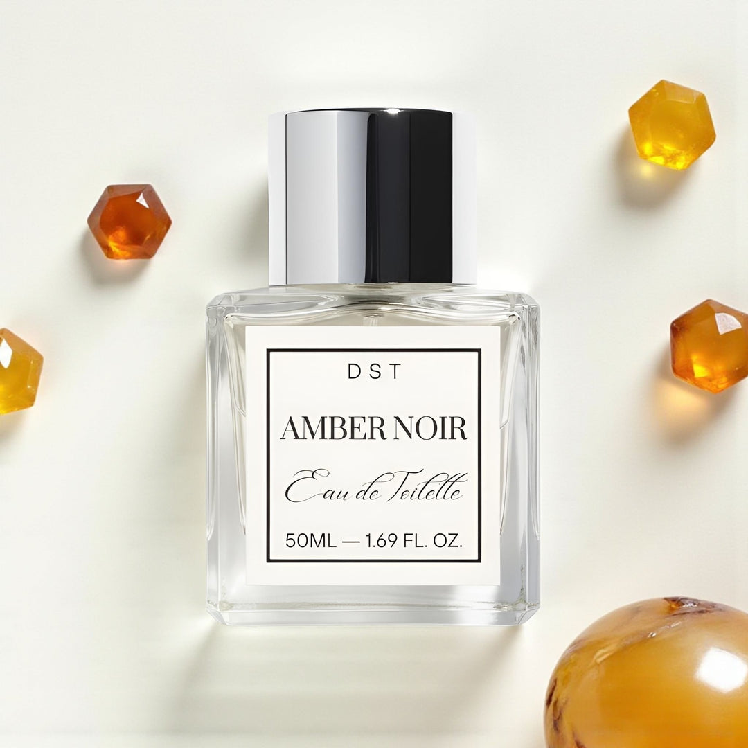 Perfume bottle labeled 'Amber Noir' with amber gemstones on a white background