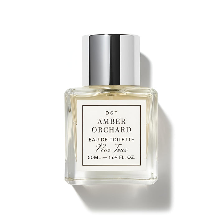 Perfume bottle labeled 'Amber Orchard' by DST on a white background