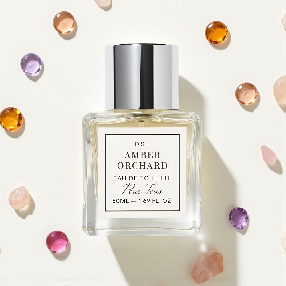 Perfume bottle labeled 'Amber Orchard' surrounded by colorful gemstones on a white background