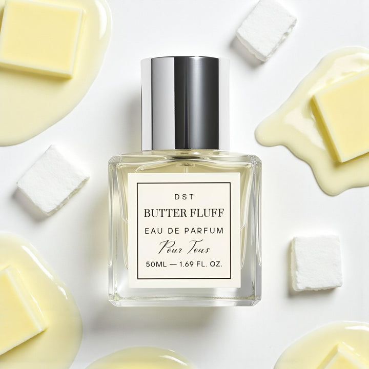 DST Fragrances Perfume bottle labeled 'Butter Fluff' surrounded by marshmallows and melted butter on an ivory background.
