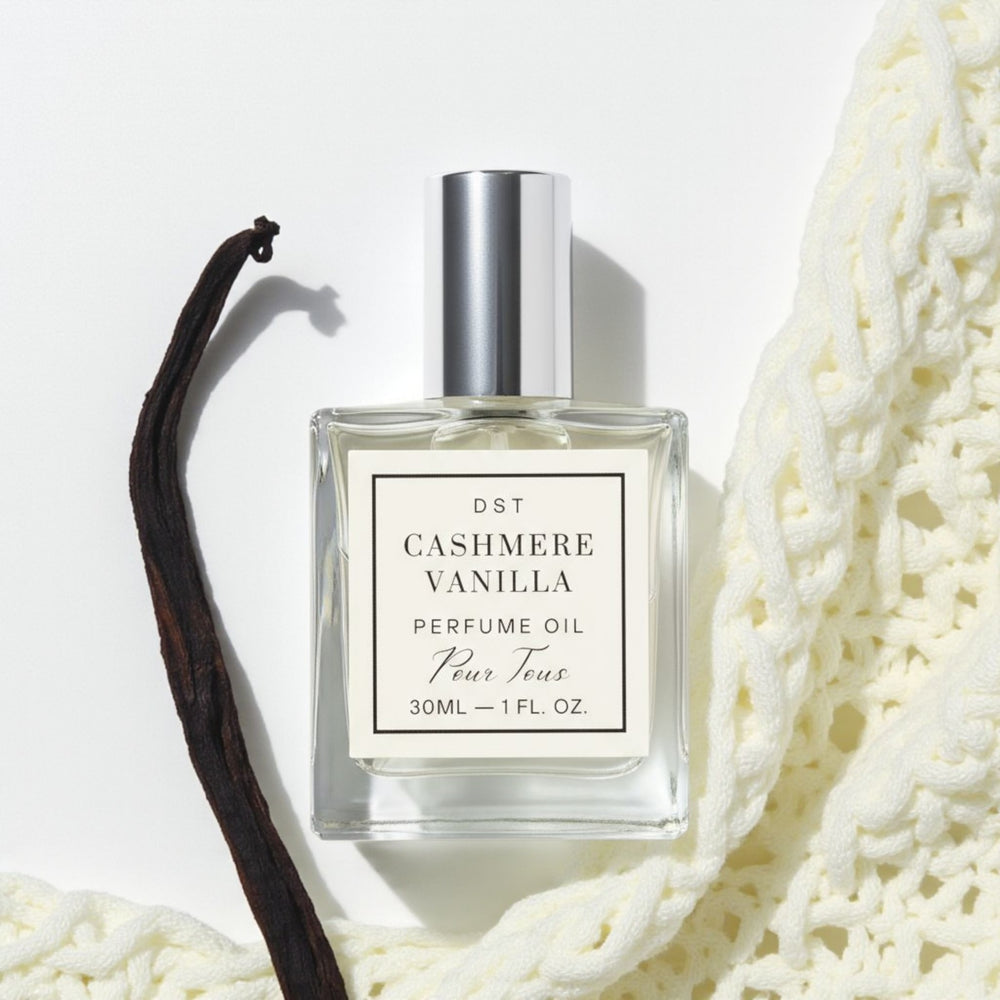 Cashmere Vanilla Perfume Oil on a ivory backdrop with vanilla bean and cashm