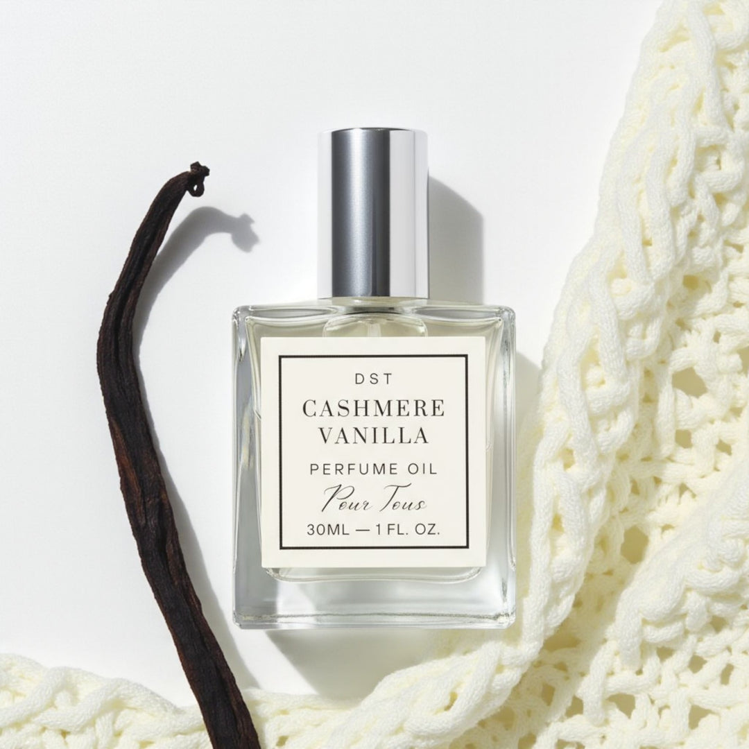 Cashmere Vanilla Perfume Oil on a ivory backdrop with vanilla bean and cashm