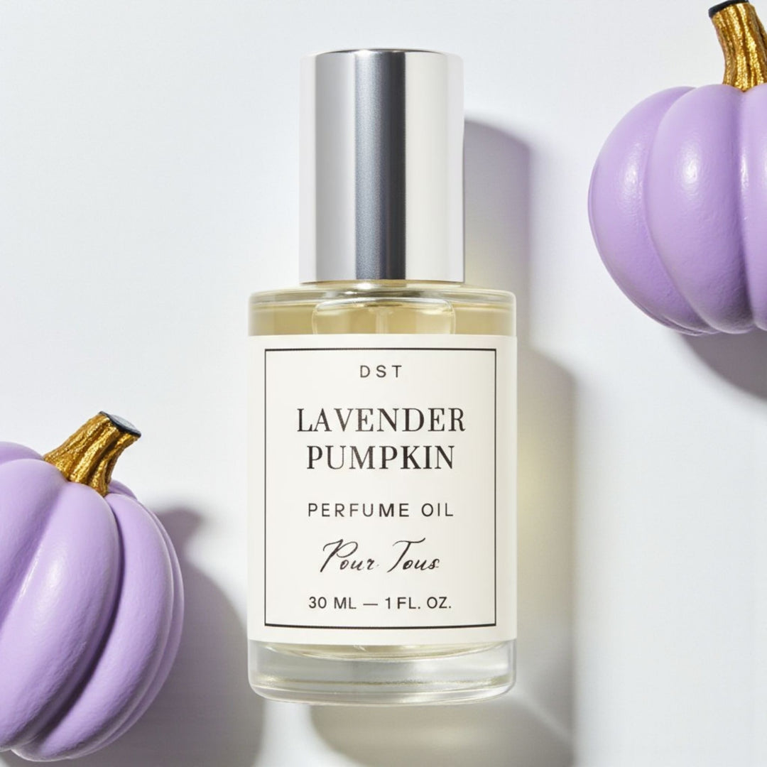 DST Fragrances Perfume oil bottle labeled 'Lavender Pumpkin' surrounded by purple pumpkins on a light background