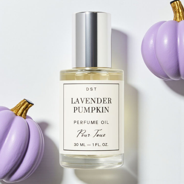 DST Fragrances Perfume oil bottle labeled 'Lavender Pumpkin' surrounded by purple pumpkins on a light background
