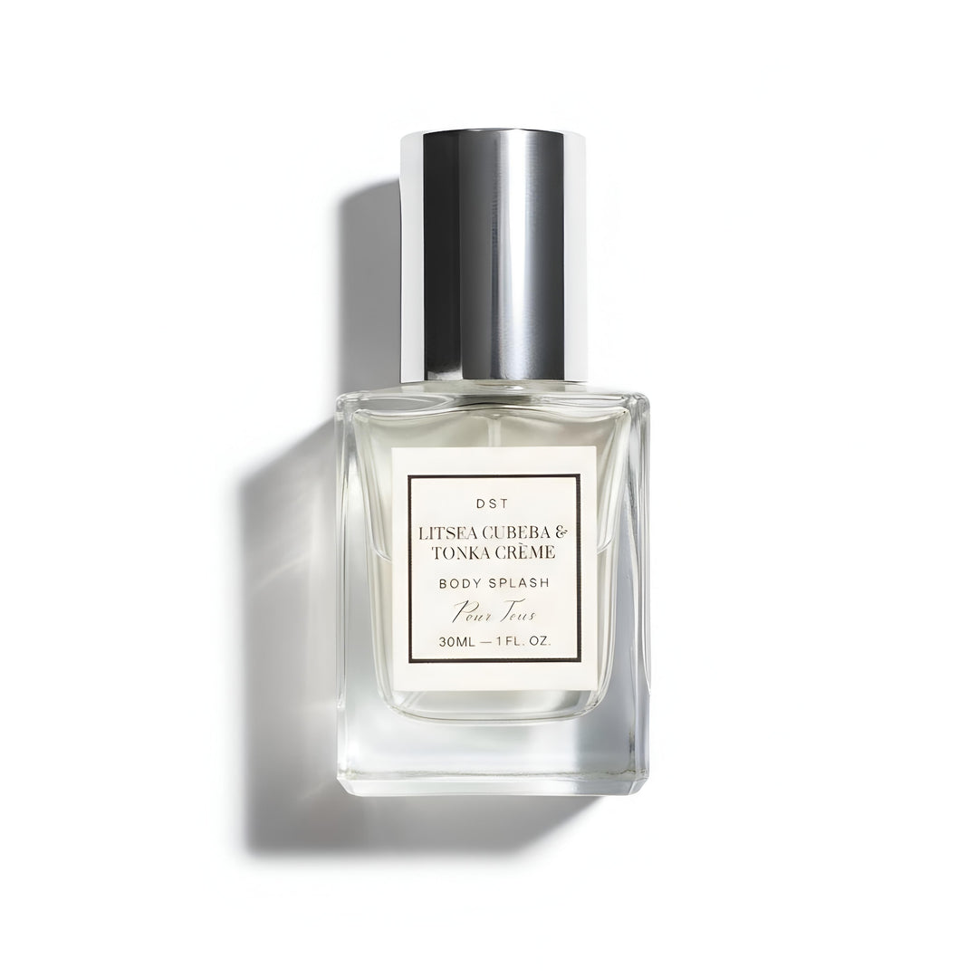 Clear perfume bottle with silver cap on a white background