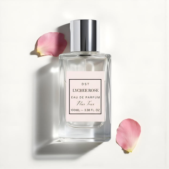Perfume bottle labeled 'Lychee Rose' with pink petals on a light background