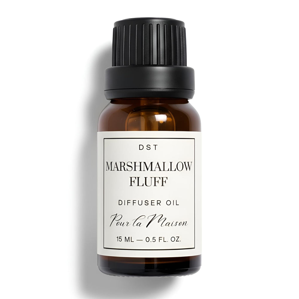 Bottle of Marshmallow Fluff diffuser oil with marshmallows on a light blue background