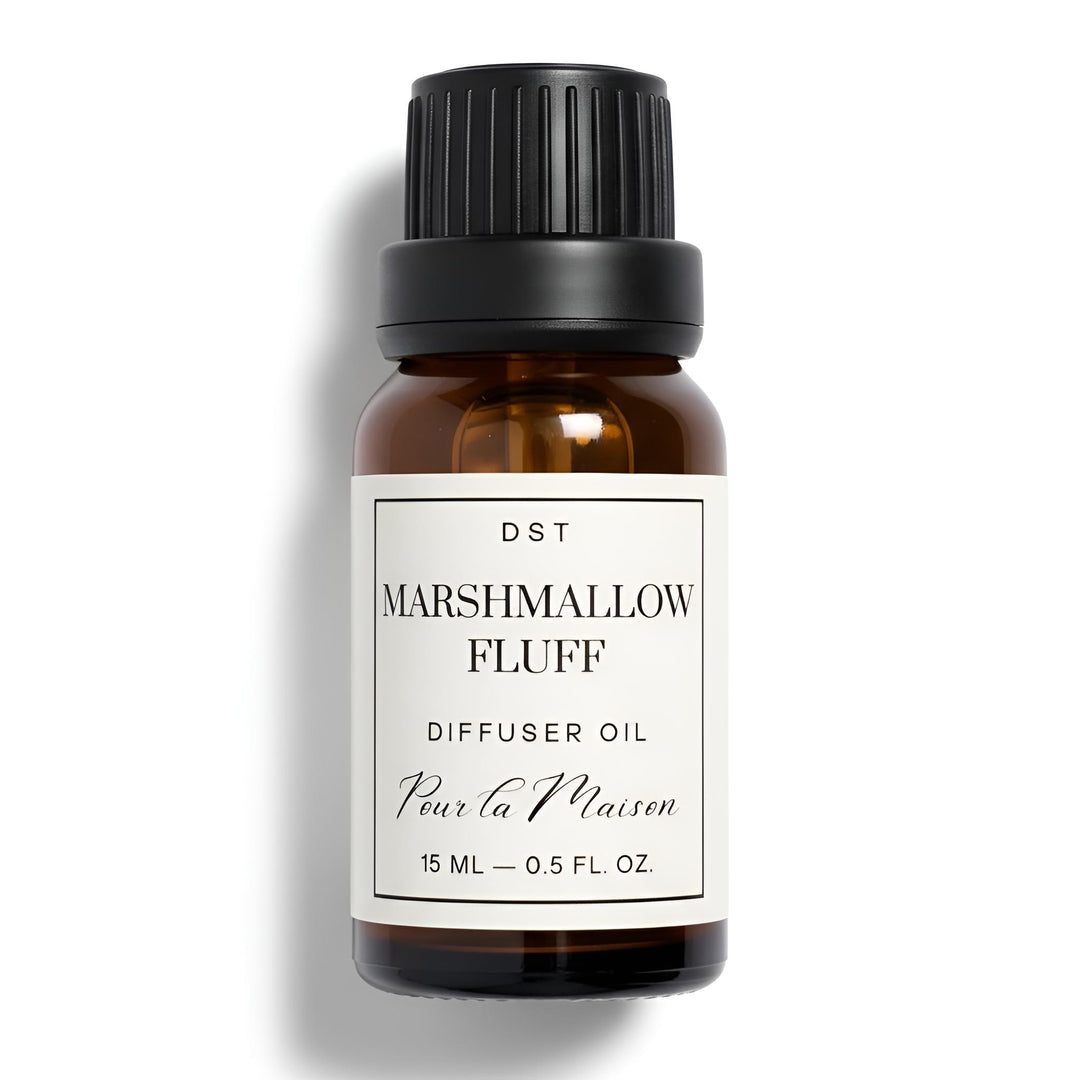 Bottle of Marshmallow Fluff diffuser oil with marshmallows on a light blue background