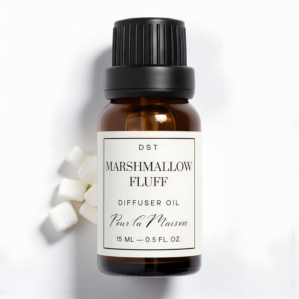 Diffuser oil bottle labeled 'Marshmallow Fluff' with packaging on a light blue background