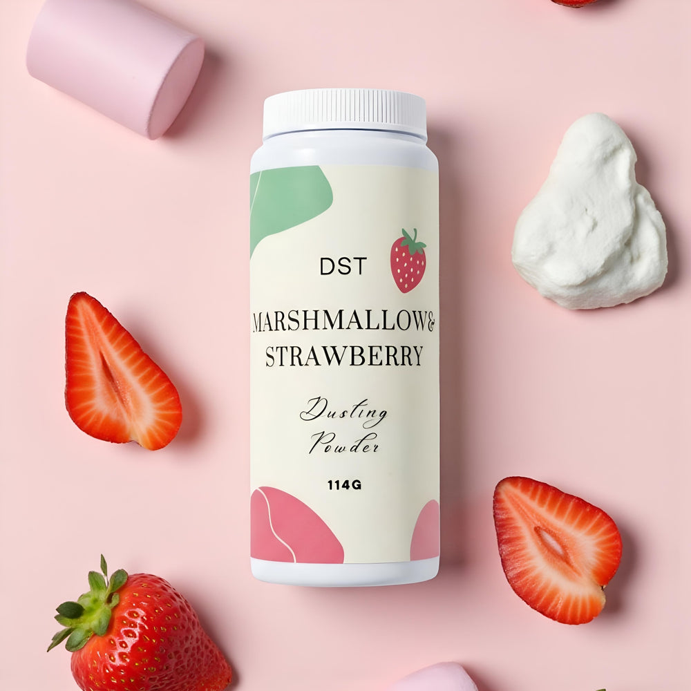 Bottle of DST Marshmallow & Strawberry Dusting Powder surrounded by strawberries and marshmallows on a pink background