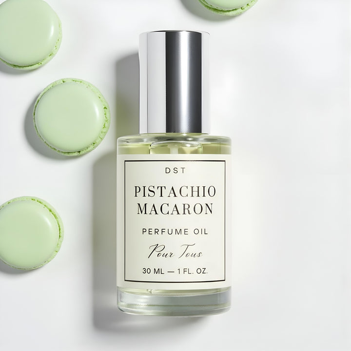 DST Fragrances Perfume oil bottle labeled 'Pistachio Macaron' with green French macarons on a n ivory background