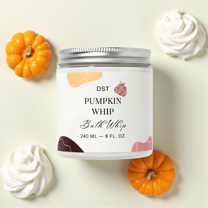 Jar of DST Pumpkin Whip Bath Whip with pumpkins and whipped cream in the background