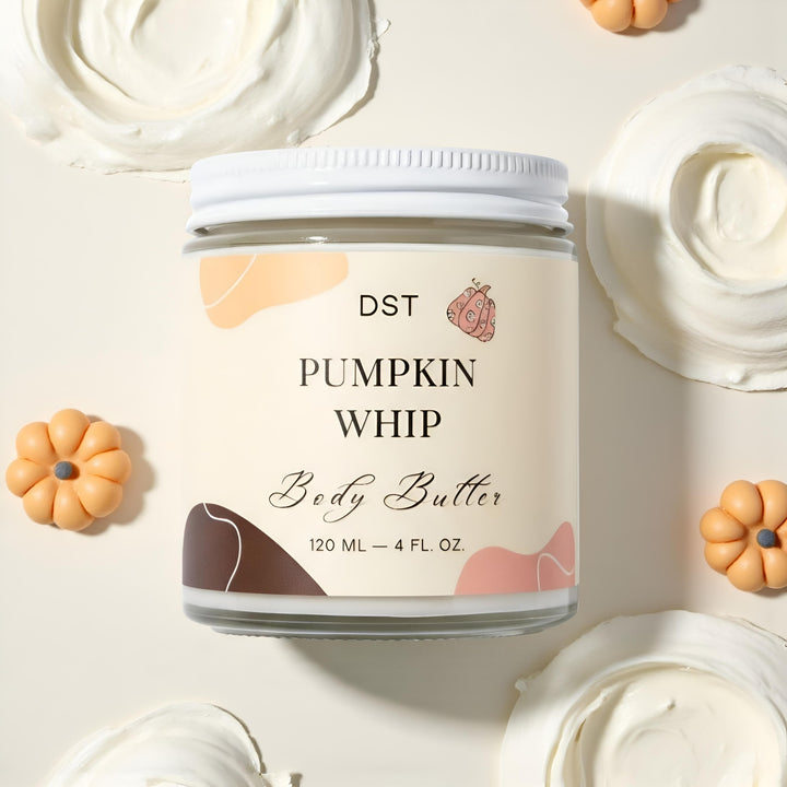 Jar of DST Pumpkin Whip Body Butter with decorative pumpkins on a light background