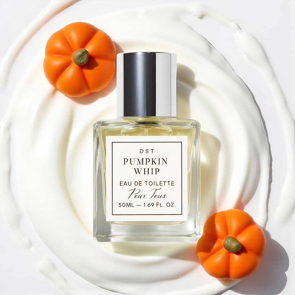 Perfume bottle labeled 'Pumpkin Whip' with small pumpkins on a light background