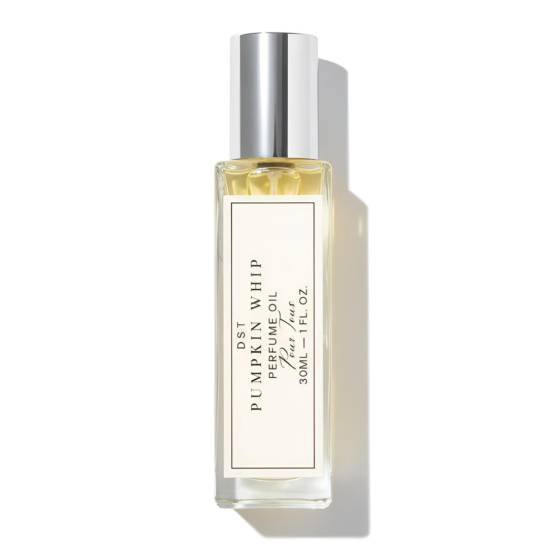 Perfume oil bottle with a gold label on a white background