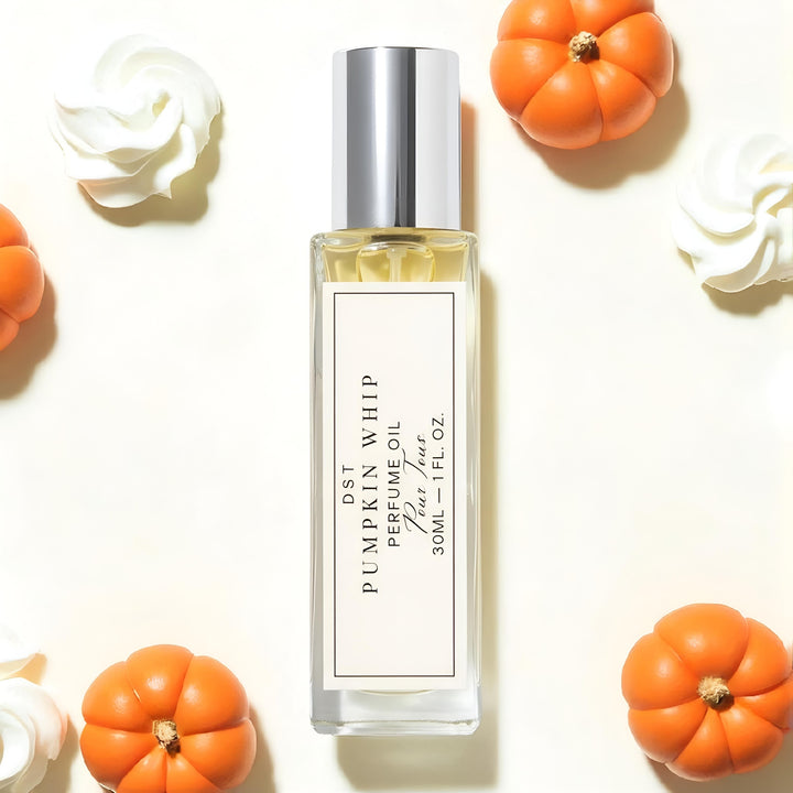 Perfume oil bottle labeled 'Pumpkin Whip' with decorative pumpkins and whipped cream on a light background