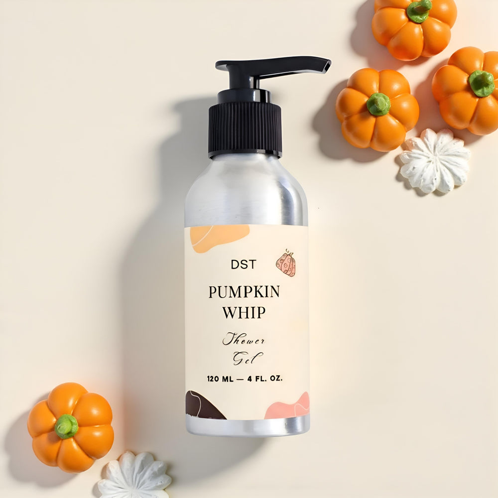 Bottle of DST Pumpkin Whip Shower Gel with pump, pumpkins, and cream on a light background