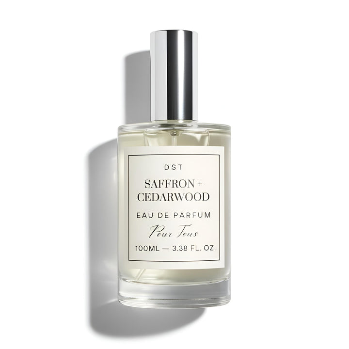 Perfume bottle labeled 'Saffron + Cedarwood' on a white background