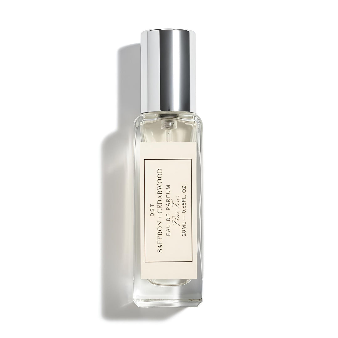 Small perfume bottle with silver cap on a white background