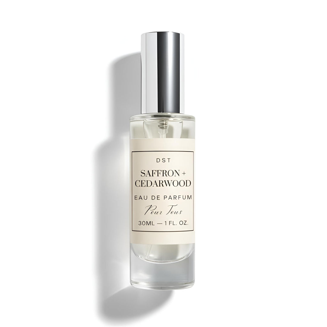 Perfume bottle labeled 'Saffron + Cedarwood' on a white background