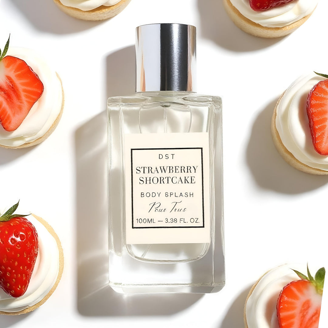 Perfume bottle labeled 'Strawberry Shortcake' with strawberry shortcake desserts in the background