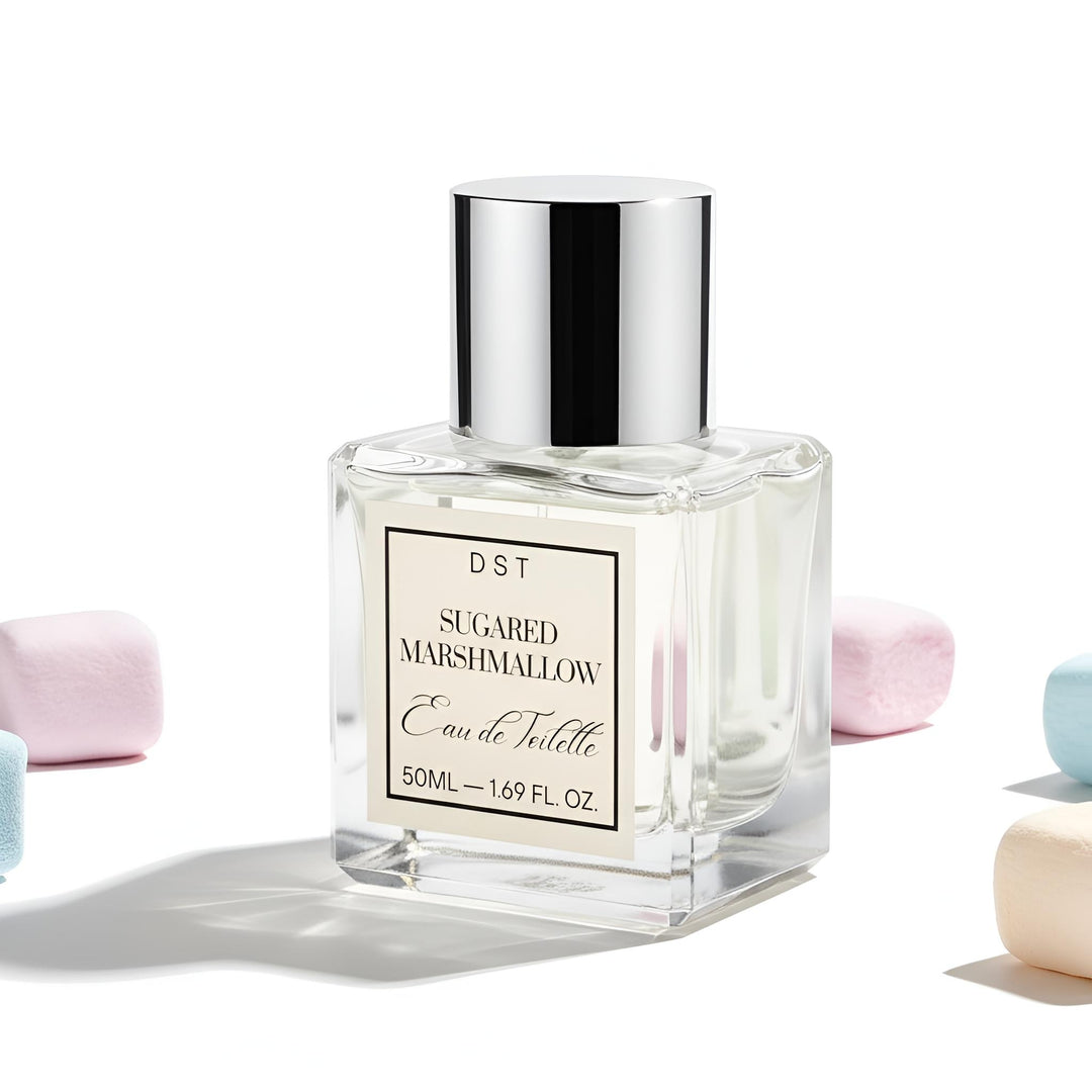 Perfume bottle labeled 'Sugared Marshmallow' by DST on a light background with pastel colored marshmallows.