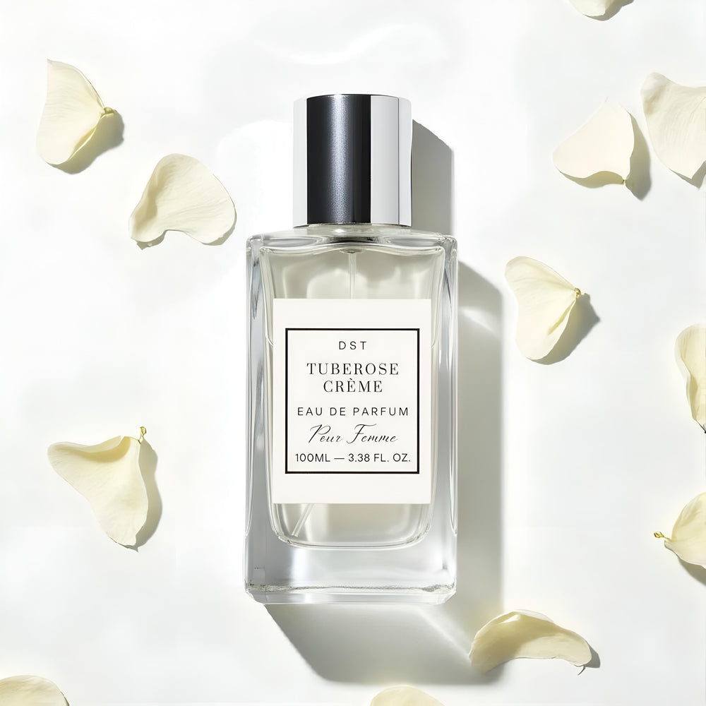 Perfume bottle labeled 'Tuberose Creme' on a light background with floral elements