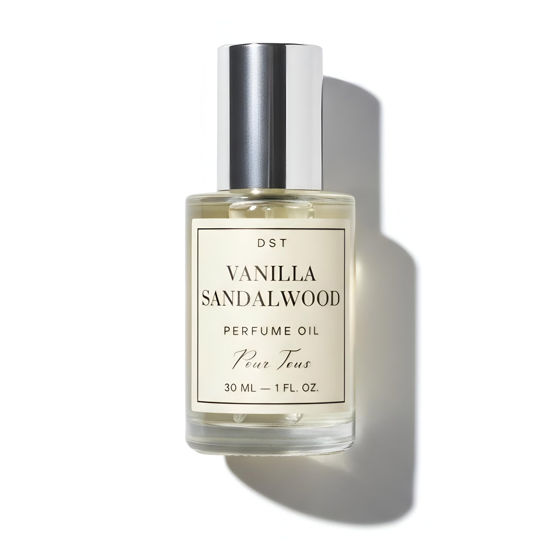 Vanilla Sandalwood perfume oil bottle on a dark slate surface with a light gray background