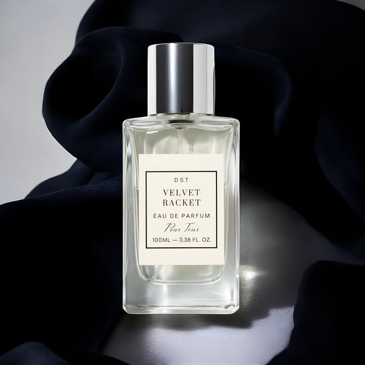 Perfume bottle labeled 'Velvet Racket' with a black and white label on a dark background