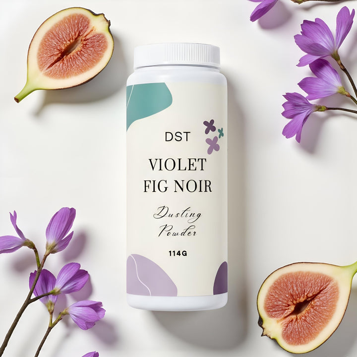 Bottle of DST Violet Fig Noir dusting powder with purple flowers and figs on a light background