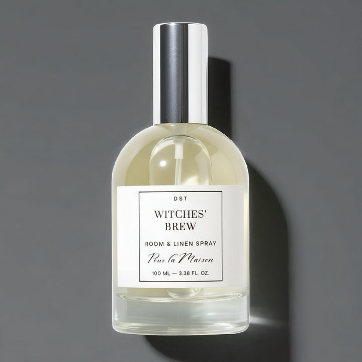 Bottle of 'Witches' Brew' room & linen spray with a gray background