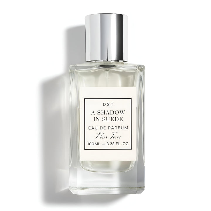 A 100ml bottle of DST's "A Shadow in Suede" Eau de Parfum against a white background.