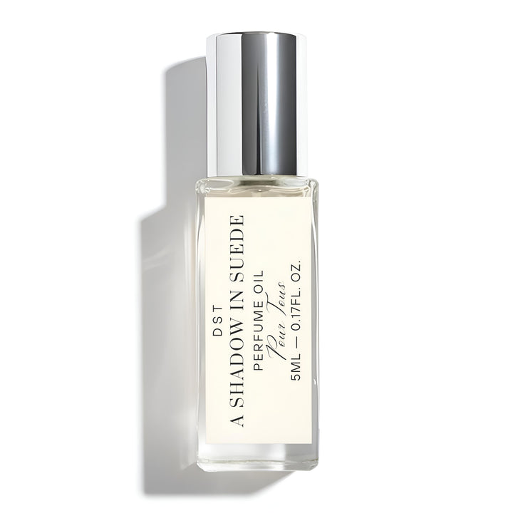 Perfume bottle labeled 'A Shadow in Suede' on a white background
