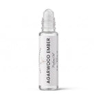 A clear glass rollerball bottle of Agarwood Ember perfume oil with a white label, shown on a clean white background.
