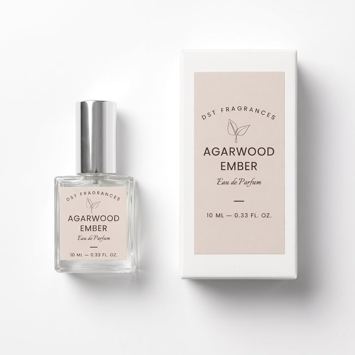 10ml bottle of Agarwood Ember eau de parfum and its box by DST Fragrances against a white background.