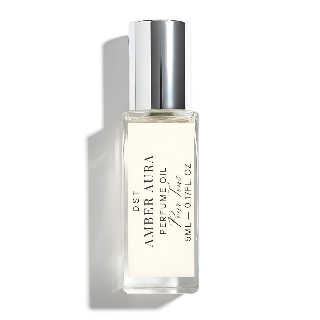 Amber Aura perfume oil bottle with silver cap on a white background