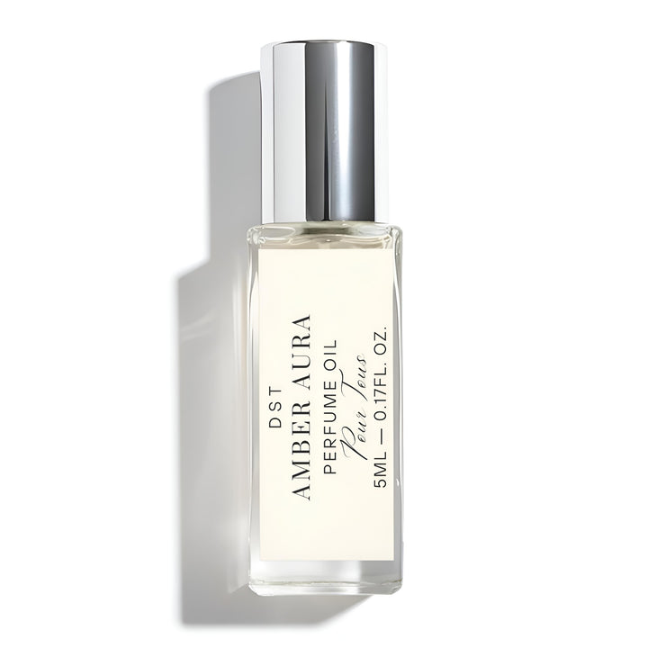 Amber Aura perfume oil bottle with silver cap on a white background