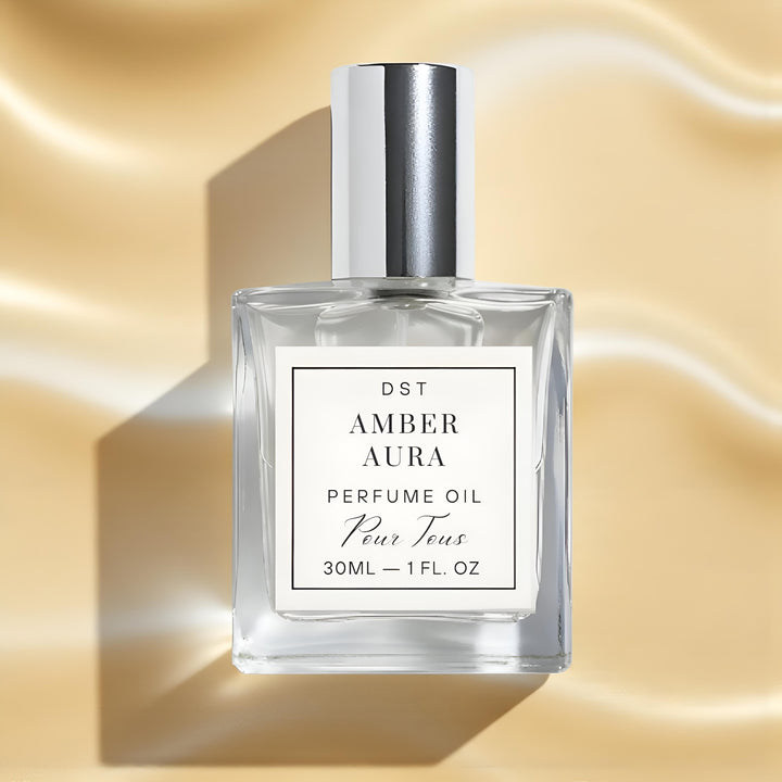 Perfume oil bottle labeled 'AMBER AURA' on a gold background