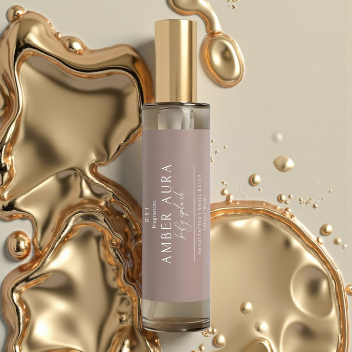 100ml bottle of Amber Aura scented Body Splash by DST Fragrances against a molten gold background.