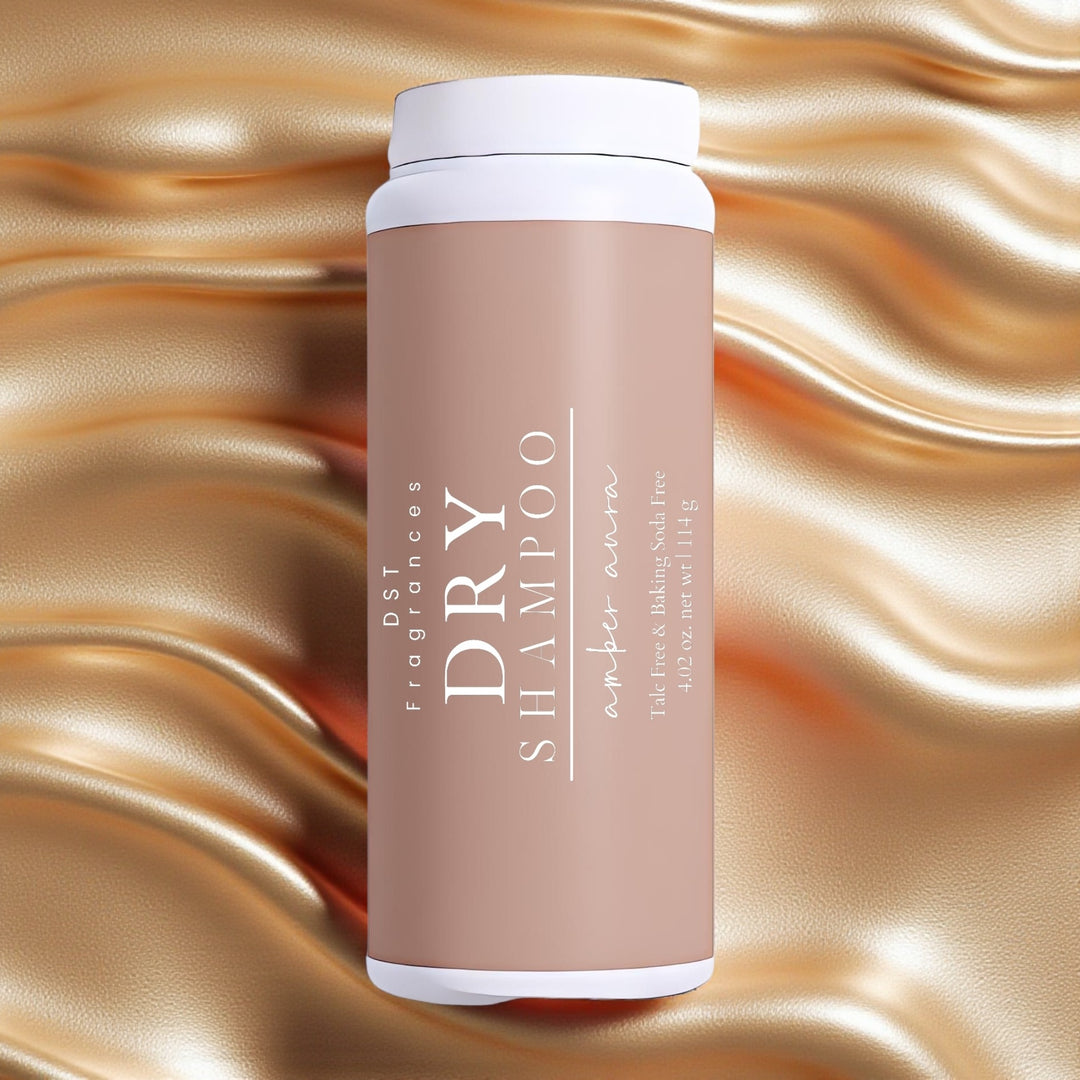 114g bottle of Amber Aura scented Dry Shampoo Powder by DST Fragrances against a molten gold background.