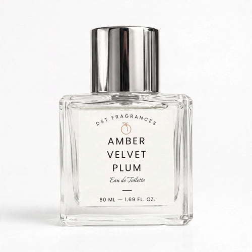 A 50 ml clear glass perfume bottle with a reflective silver cap, labeled 'AMBER VELVET PLUM' by DST FRAGRANCES, on a clean white background.