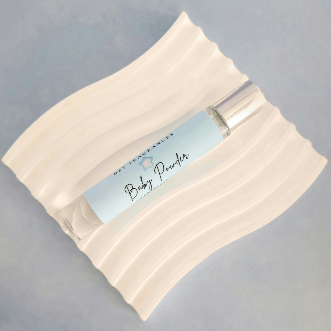 10ml bottle of Baby Powder perfume oil against a grey background. 