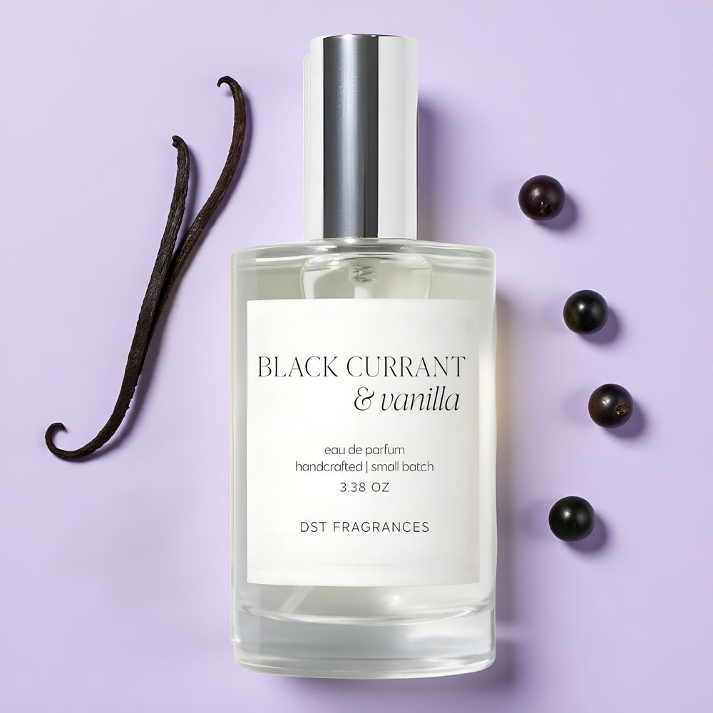 100ml bottle of 'Black Currant & Vanilla' Eau de Parfum by DST Fragrances with vanilla bean and black currants on a purple background.