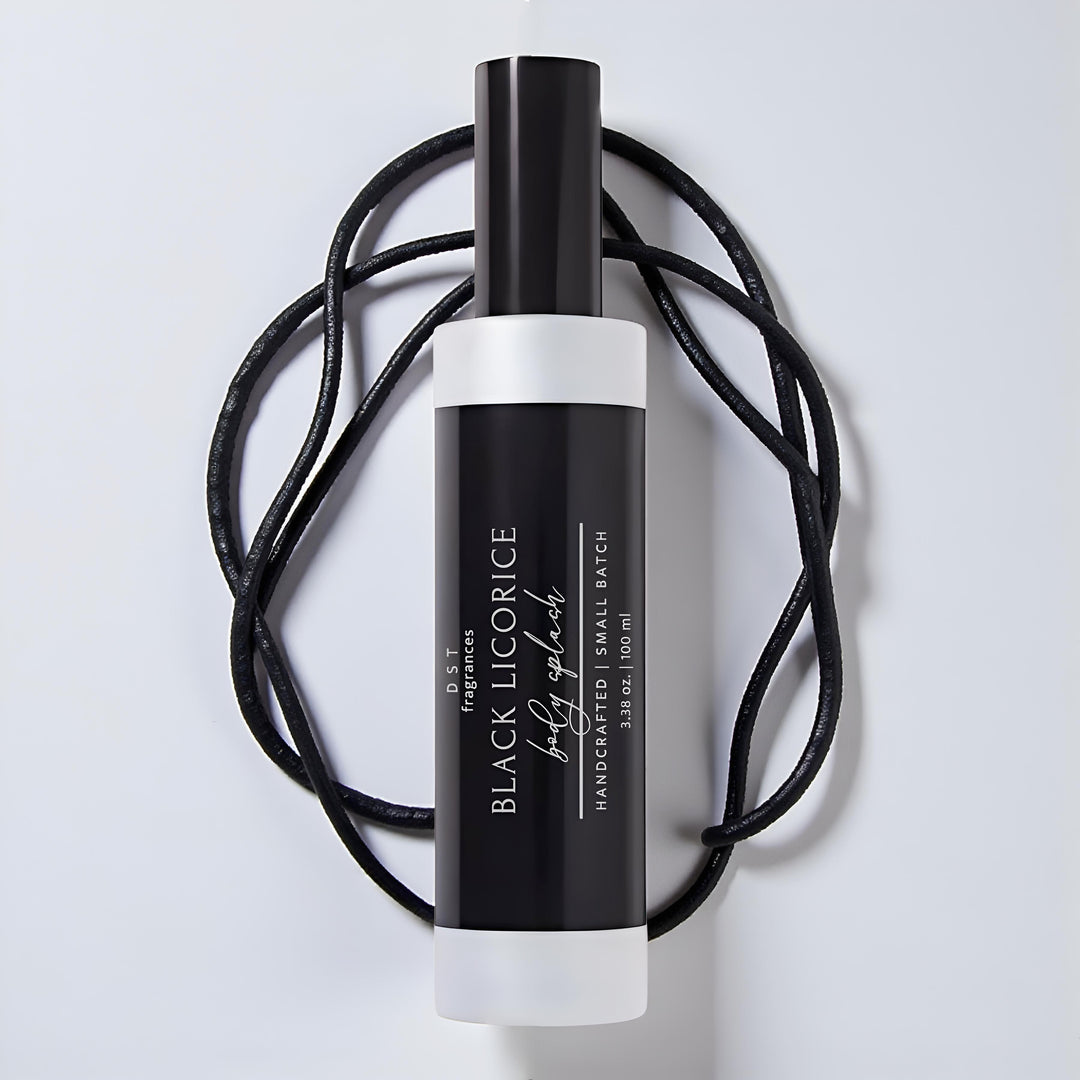 Black licorice body splash bottle with white cap on a light gray background
